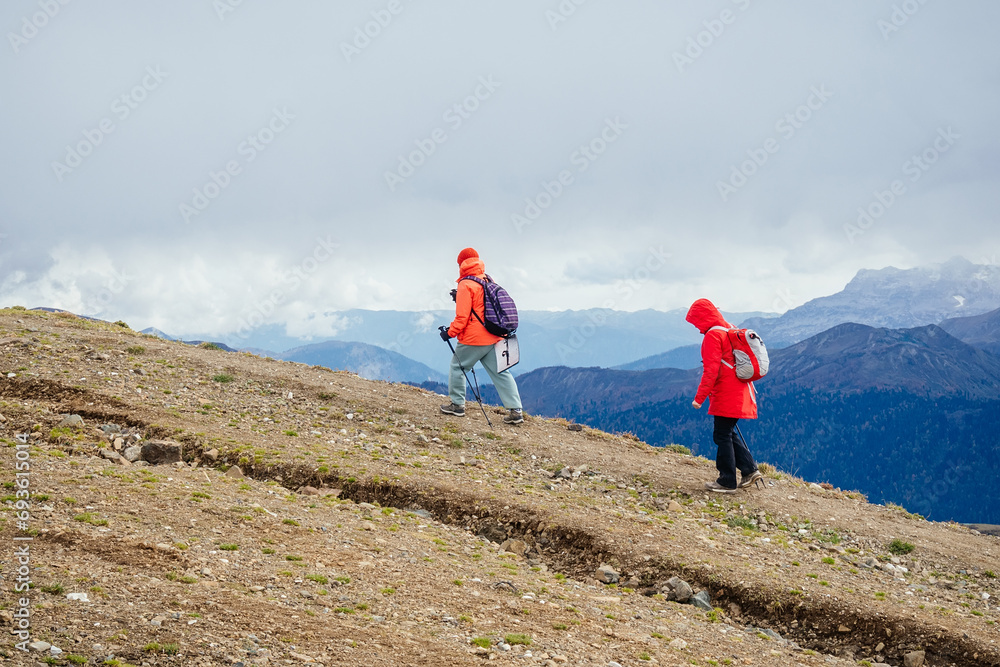 Two women hiking high in the mountains in late autumn