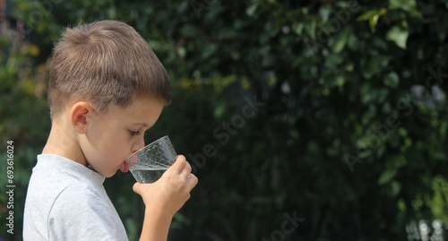 Child drinks water. Selective focus.