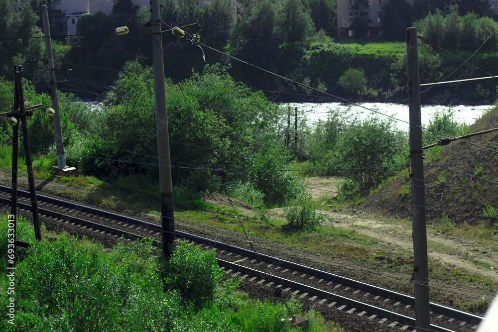 A railway illuminated by the rays of the sun, among the trees. A railway illuminated by the rays of the sun, among the trees.