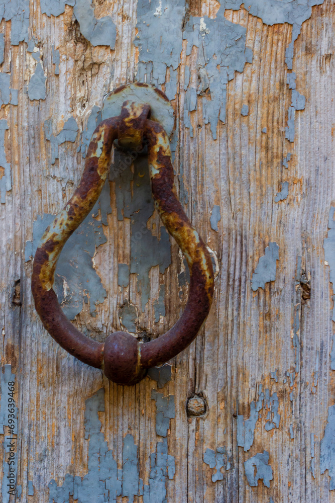 Weathered Wooden Door with Rusty Iron Knocker Weathered Wooden Door with Rusty Iron Knocker