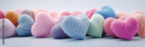 colorful knitted hearts with colored background for valentine's day, babyshower, presentation