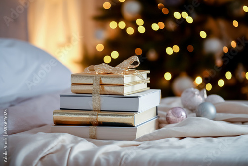 On the white bed lies a Christmas gift of beautifully packaged books.