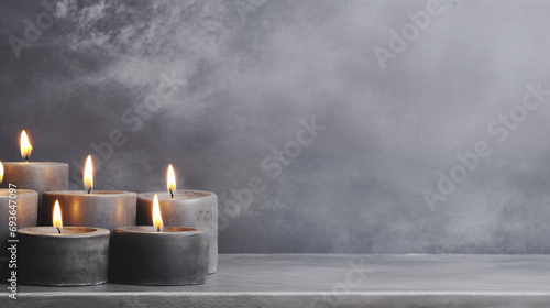 Background for design with copy space. Burning candles on cement background. photo