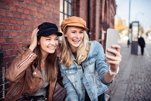 Young lesbian women taking selfie in the city photo