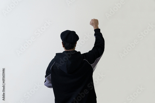 man showing fist gesture black dark silhouette  image from behind