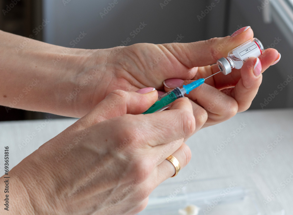 Close upshot of the woman preparing medicine for injection. Healthcare Close upshot of the woman preparing medicine for injection. Healthcare