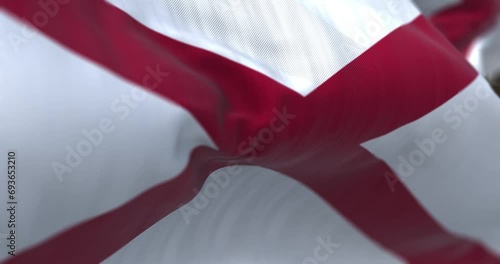 The state flag of Alabama waving in the wind on a clear day photo