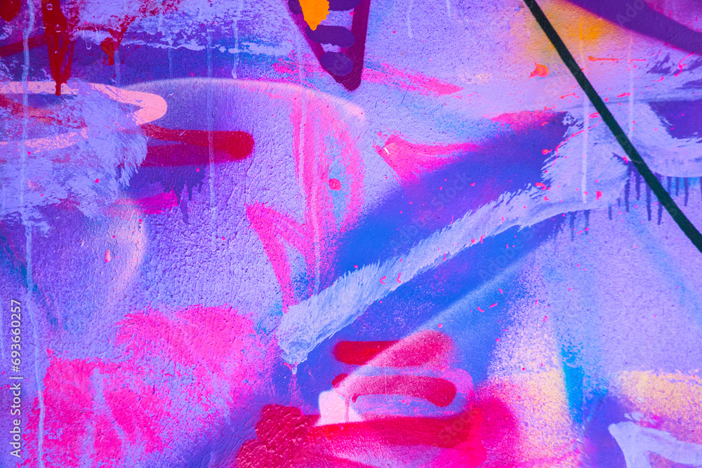 Messy paint strokes and smudges on an old painted wall. Pink, purple, white color drips, flows, streaks of paint and paint sprays Messy paint strokes and smudges on an old painted wall. Pink, purple, white color drips, flows, streaks of paint and paint sprays