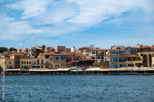 Greece  Chania Town Crete. View of outdoors cafe  seaside traditional building. Ripple sea water.