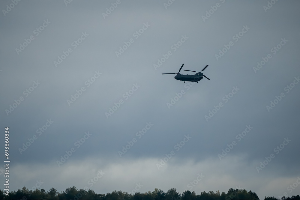 An RAF Chinook tandem-rotor CH-47 helicopter flying low on a military battle exercise, Wilts UK An RAF Chinook tandem-rotor CH-47 helicopter flying low on a military battle exercise, Wilts UK