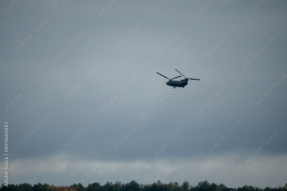 An RAF Chinook tandem-rotor CH-47 helicopter flying low on a military battle exercise, Wilts UK An RAF Chinook tandem-rotor CH-47 helicopter flying low on a military battle exercise, Wilts UK