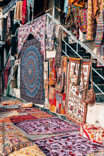 carpets are on sale at udaipur street, india © jon_chica