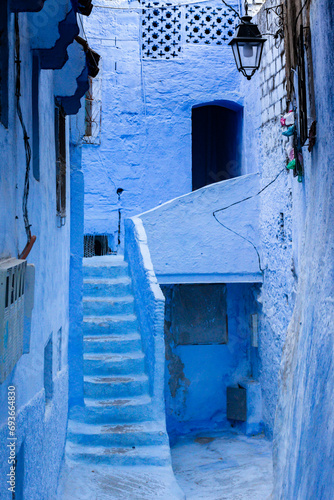Old narrow blue painted street in the medina of Chefchaouen, Morocco © Vicente Sargues