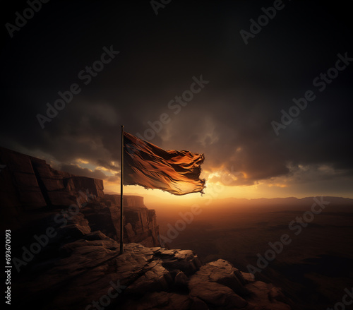 Tattered flag waving in the wind on a mountain overlooking a desert photo