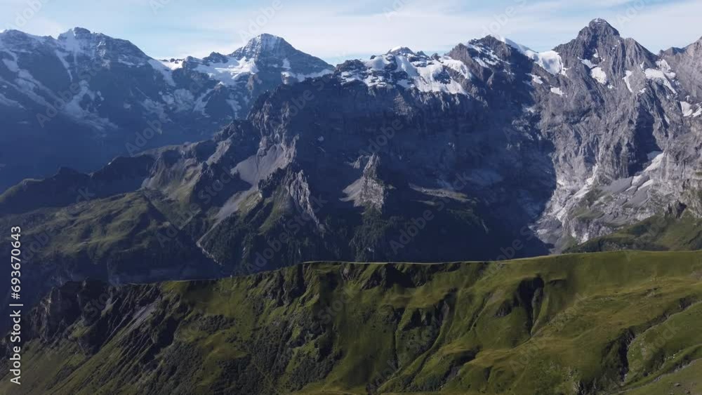 Aerial view above cliffs, rocky mountains and valleys with lakes and rivers at Birg to Schilthorn. Snow-capped peaks of Bernese Prealps, Canton of Bern, Switzerland. Bernese Oberland, Jungfrau Region. Aerial view above cliffs, rocky mountains and valleys with lakes and rivers at Birg to Schilthorn. Snow-capped peaks of Bernese Prealps, Canton of Bern, Switzerland. Bernese Oberland, Jungfrau Region.
