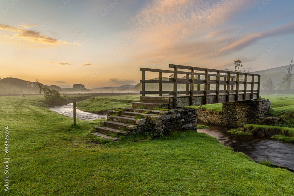 Sunrise at the footbridge over Gayle Beck near the picturesque market town of Hawes in the Yorkshire Dales