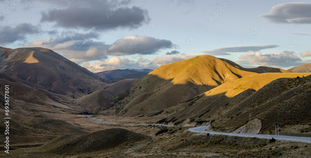 Lindis pass during sunset with country side road in New Zealand.