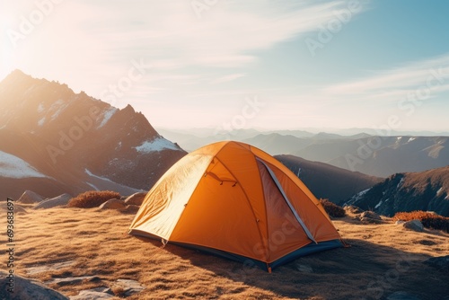 a tent is pitched in the mountains and the sun is shining © olegganko