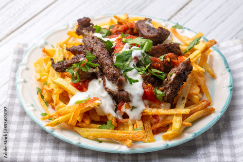 Turkish food; Cokertme Kebab - Beef meat kebab with yoghurt and french fries
