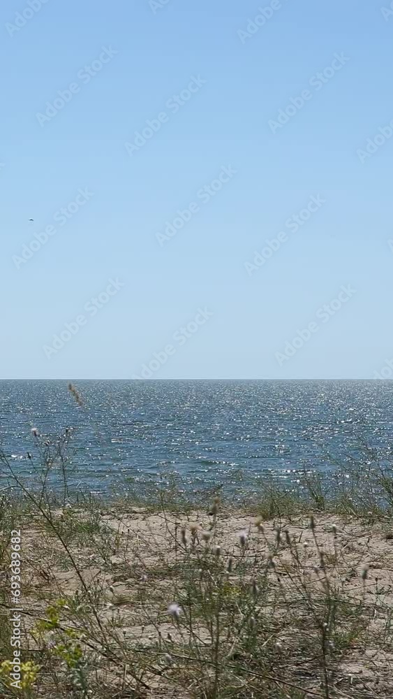 Seascape on a sunny summer day with a yacht in the background Seascape on a sunny summer day with a yacht in the background