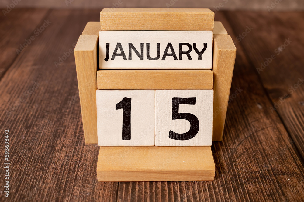 January 15 calendar date text on white wooden block with stationeries on wooden desk. Calendar date concept. January 15 calendar date text on white wooden block with stationeries on wooden desk. Calendar date concept.