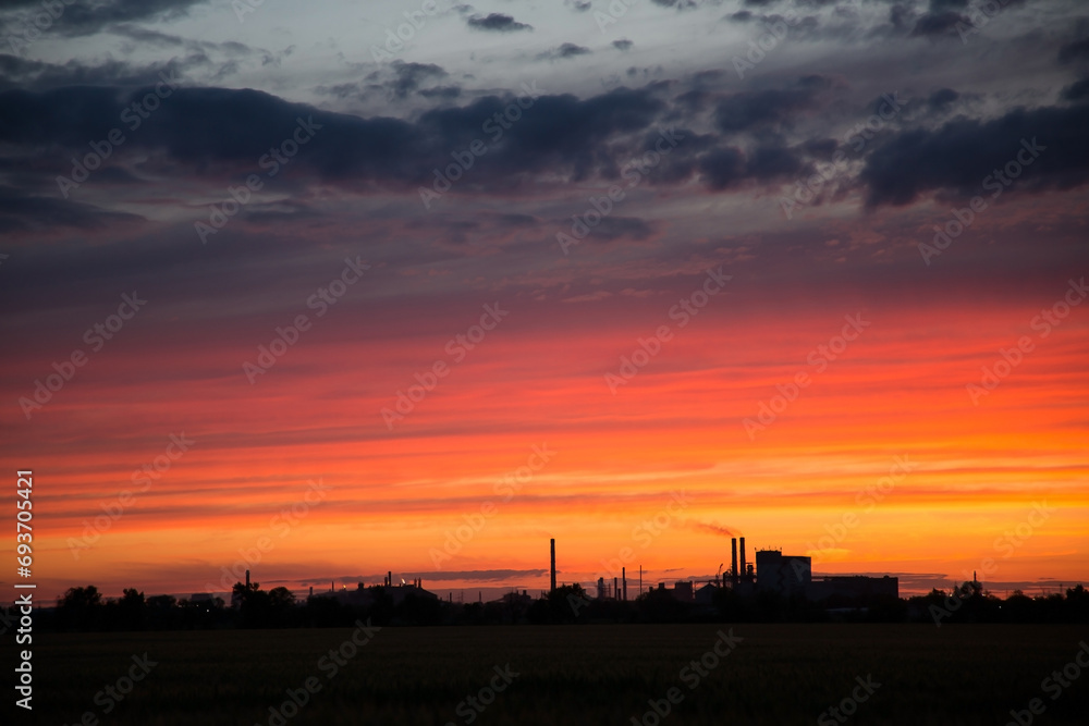 Beautiful orange sunset over a metallurgical plant Beautiful orange sunset over a metallurgical plant