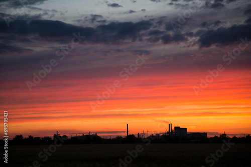Beautiful orange sunset over a metallurgical plant