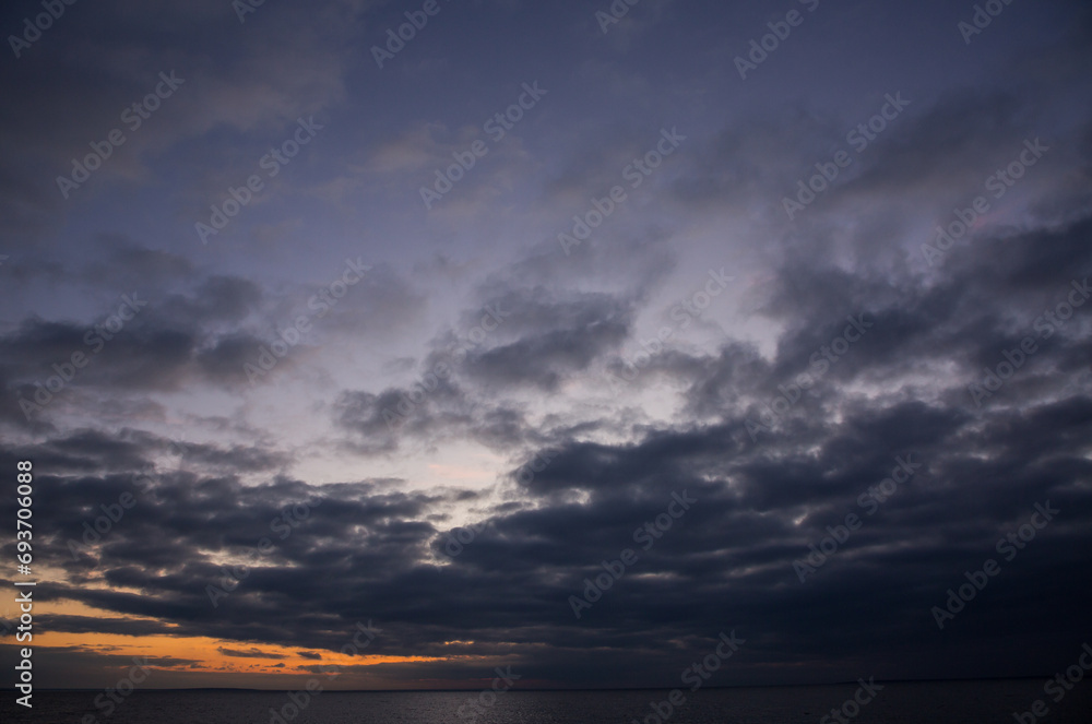 Cloudy sunset on the seashore, beautiful sunset by the sea Cloudy sunset on the seashore, beautiful sunset by the sea
