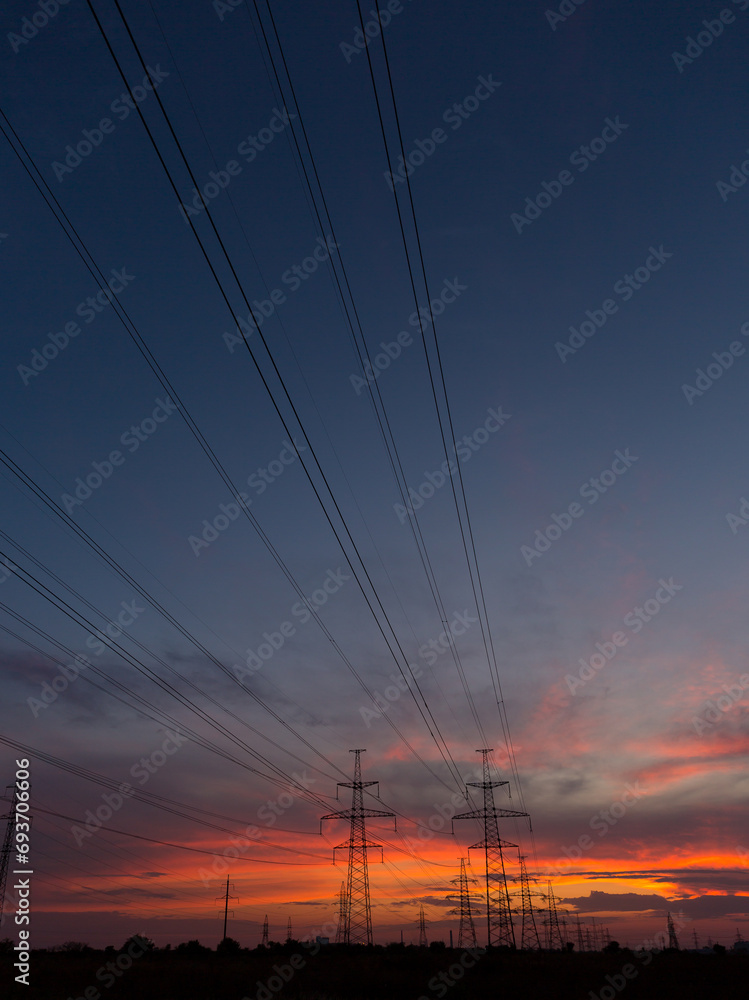 Orange sunset and power lines, high voltage power line