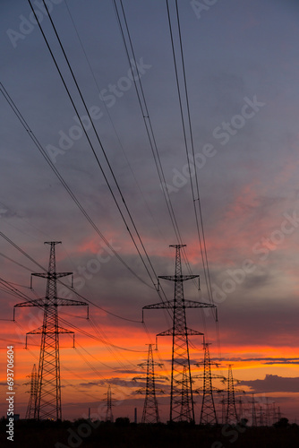 Orange sunset and power lines, high voltage power line