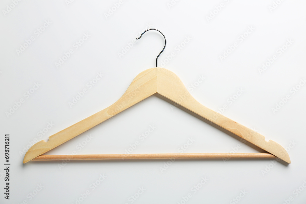 One wooden hanger on white background, top view One wooden hanger on white background, top view