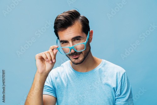 Blue man trendy lifestyle glasses t-shirt fashion portrait modern style beard background smile