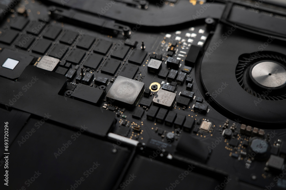 a disassembled laptop, close up shot, black circuit board of computer