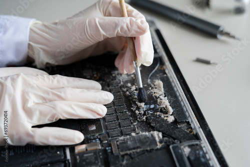 cleaning a laptop inside from dust and dirt, service maintenance