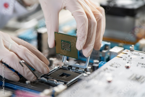 process of Installation of processor in CPU socket, hands in gloves holding chip