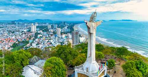 Aerial view of coastal Vung Tau city, Vietnam in the morning. The place where there is a statue of Christ on the mountain protects Vung Tau Peninsula's peace. photo