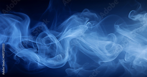 Blue smoke on a dark blue background. Abstract background for design.