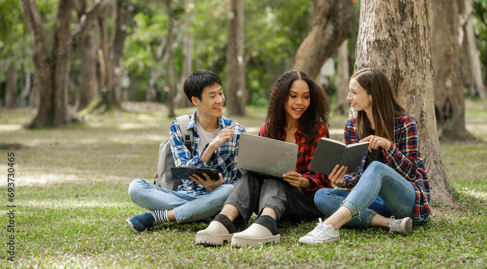 Group of young interracial diverse university students chatting together outside, engaging in a discussion together, college campus, enjoying campus recreation. Happy friends Group of young interracial diverse university students chatting together outside, engaging in a discussion together, college campus, enjoying campus recreation. Happy friends