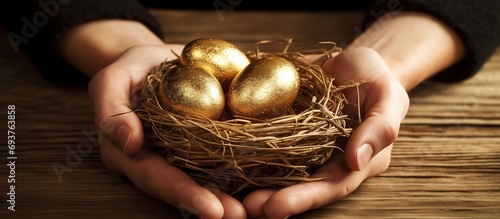 Nest with golden eggs in hand