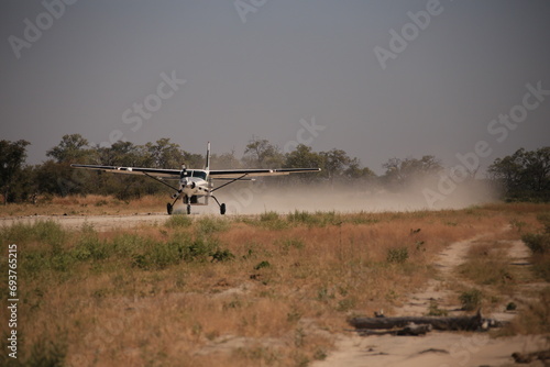 Canvas Print bush plane takes off from a african bush airstrip
