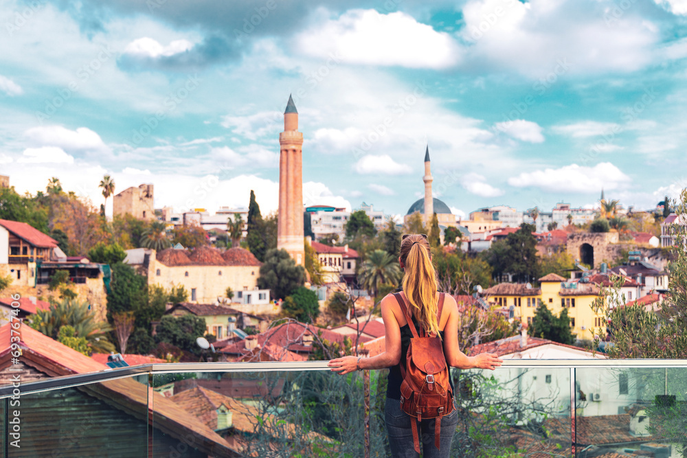 Obraz premium Woman travelling in Turkey, viewpoint of Antalya city with minaret- Turkey