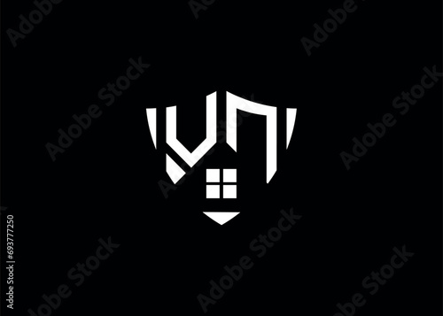 Real estate letter VN shield shape logo and house building vector template