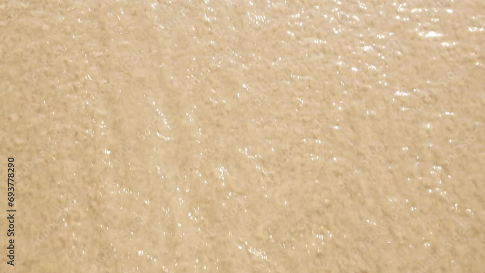 view to white sand beach surface texture with sea wave hit the beach in summer sunny sunshine day,wave swept towards the shore with white bubble waves, summer holiday vacation view to white sand beach surface texture with sea wave hit the beach in summer sunny sunshine day,wave swept towards the shore with white bubble waves, summer holiday vacation