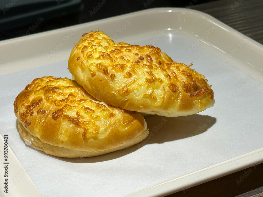 Closeup cheese bread on white tray at the table Closeup cheese bread on white tray at the table