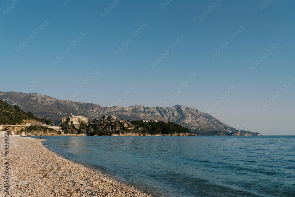 Deserted main beach of Budva overlooking the mountains by the sea. Montenegro