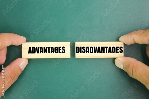 hand holding a stick with the words Advantages and Disadvantages. the concept of advantage or disadvantage of something