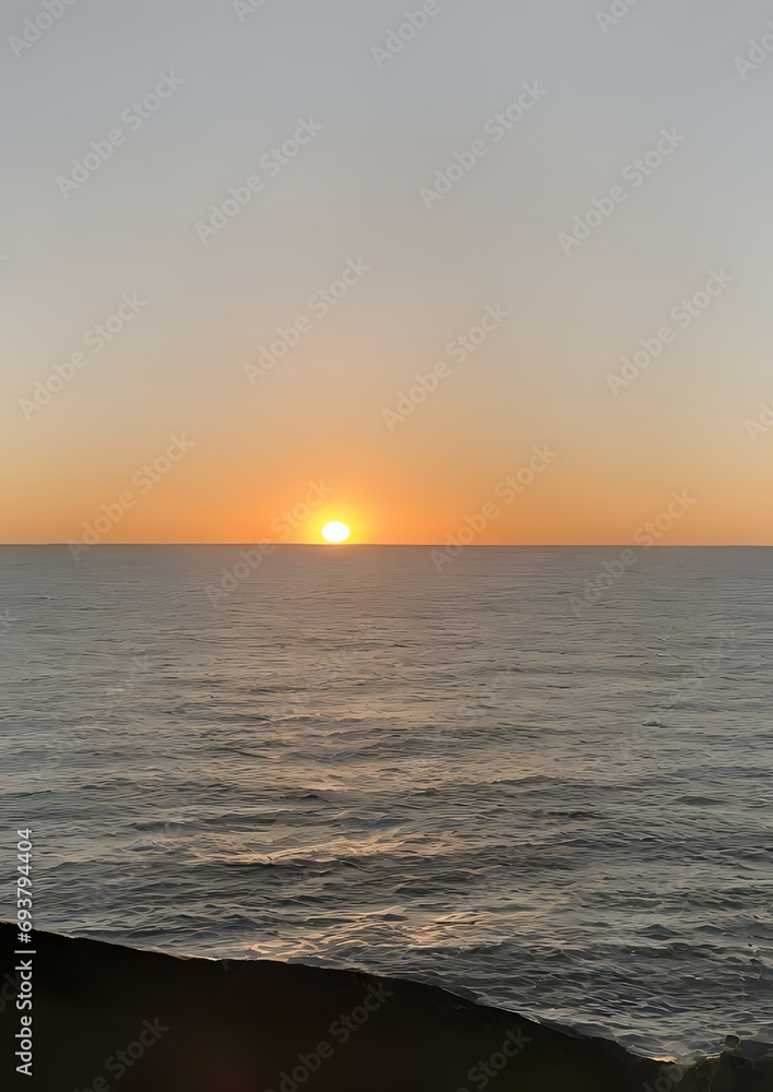 view of the sea, with the setting sun in the background