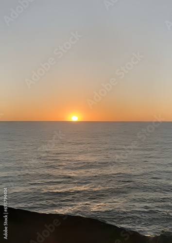 view of the sea, with the setting sun in the background