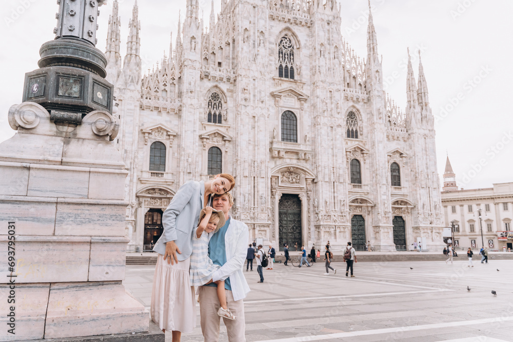 Happy family with a child on the background of the Duomo in Milan