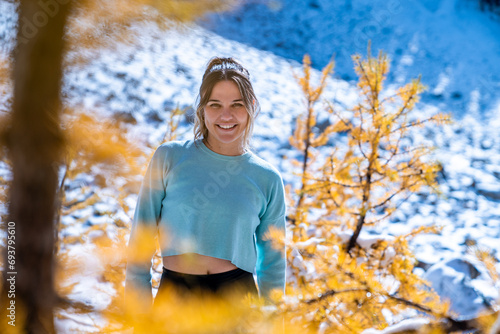 Happy Girl Smiling Among Beautiful Golden Larches photo